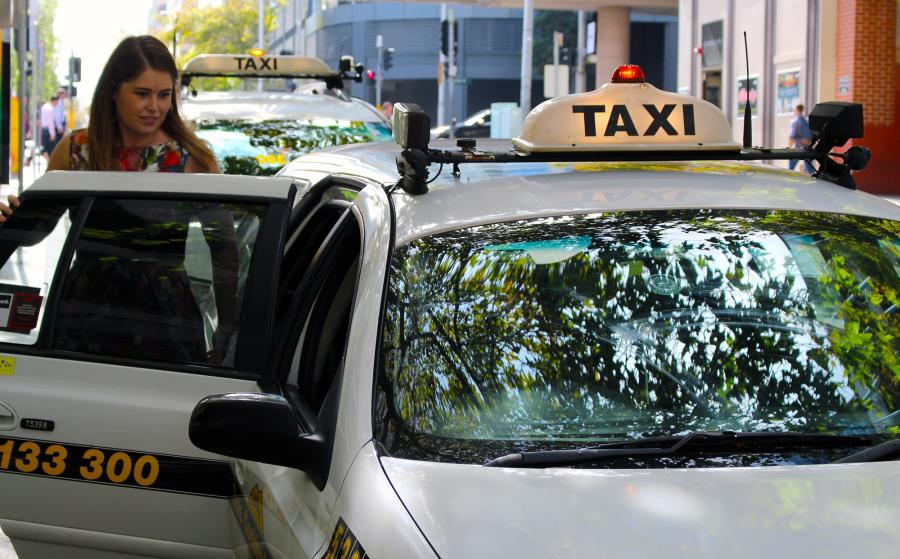 Woman getting into a Taxi