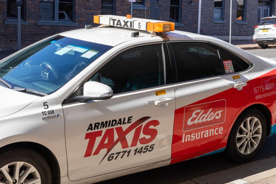 Taxi vehicle showing livery stickers
