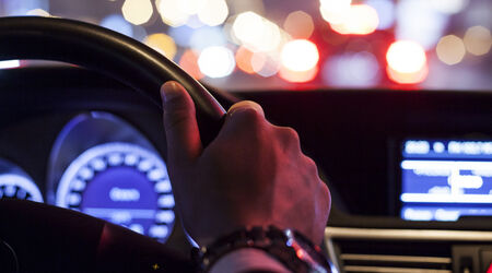 driver, night time, hand on wheel, lights, city, road