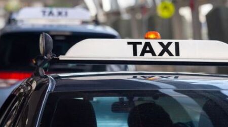 Displaying taxi fare hotline stickers 