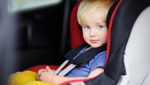 Decorative photograph of a child in a car seat