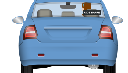 A car showing the rideshare sign being displayed in the rear window