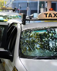 Woman getting into a Taxi