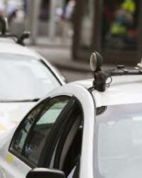 Two taxis waiting at a Taxi Stand