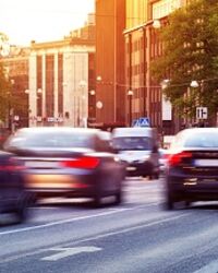 Cars driving through the city at sunset