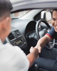 Driver shaking hands with customer or friend