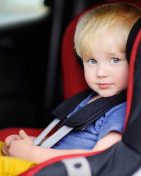 Decorative photograph of a child in a car seat